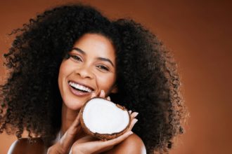 Hair, model and beauty portrait with coconut for natural curly hair care cosmetic treatment. Health