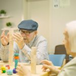 Man building a tower as skill games in a geriatric
