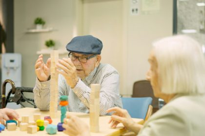 Man building a tower as skill games in a geriatric