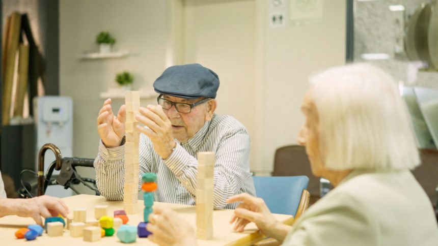 Man building a tower as skill games in a geriatric