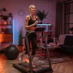 Portrait of active and dynamic young charming woman doing sport fitness at home