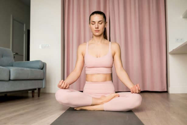 Young brunette woman with eyes closed practicing breathing exercise.